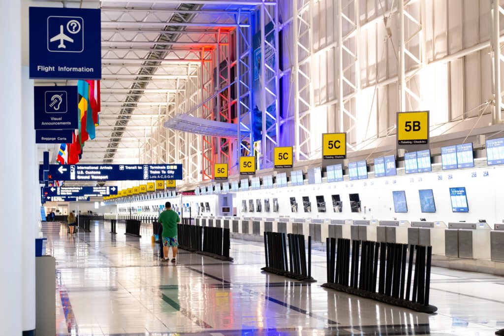 An airport terminal representing people travelling between Canada and the US for essential purposes