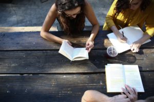 A group of students studying at a picnic table representing international students in Canada and COVID-19