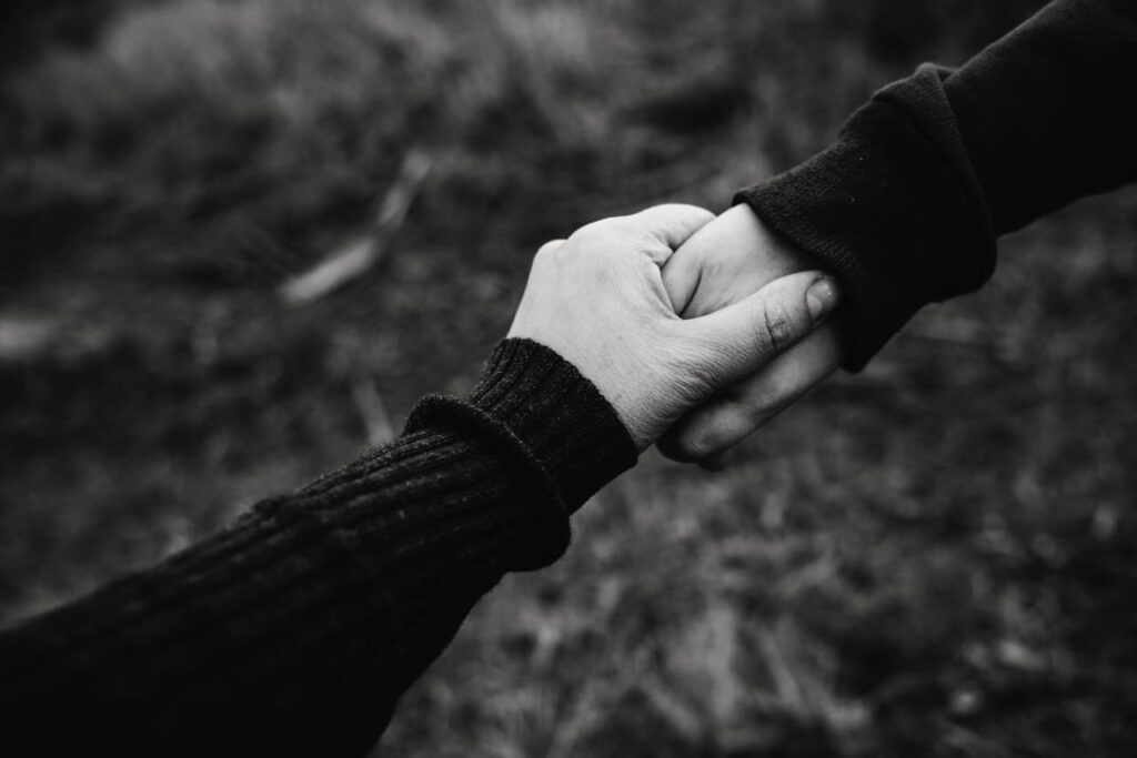 Two people holding hands representing a couple who now qualify for family admittance into Canada