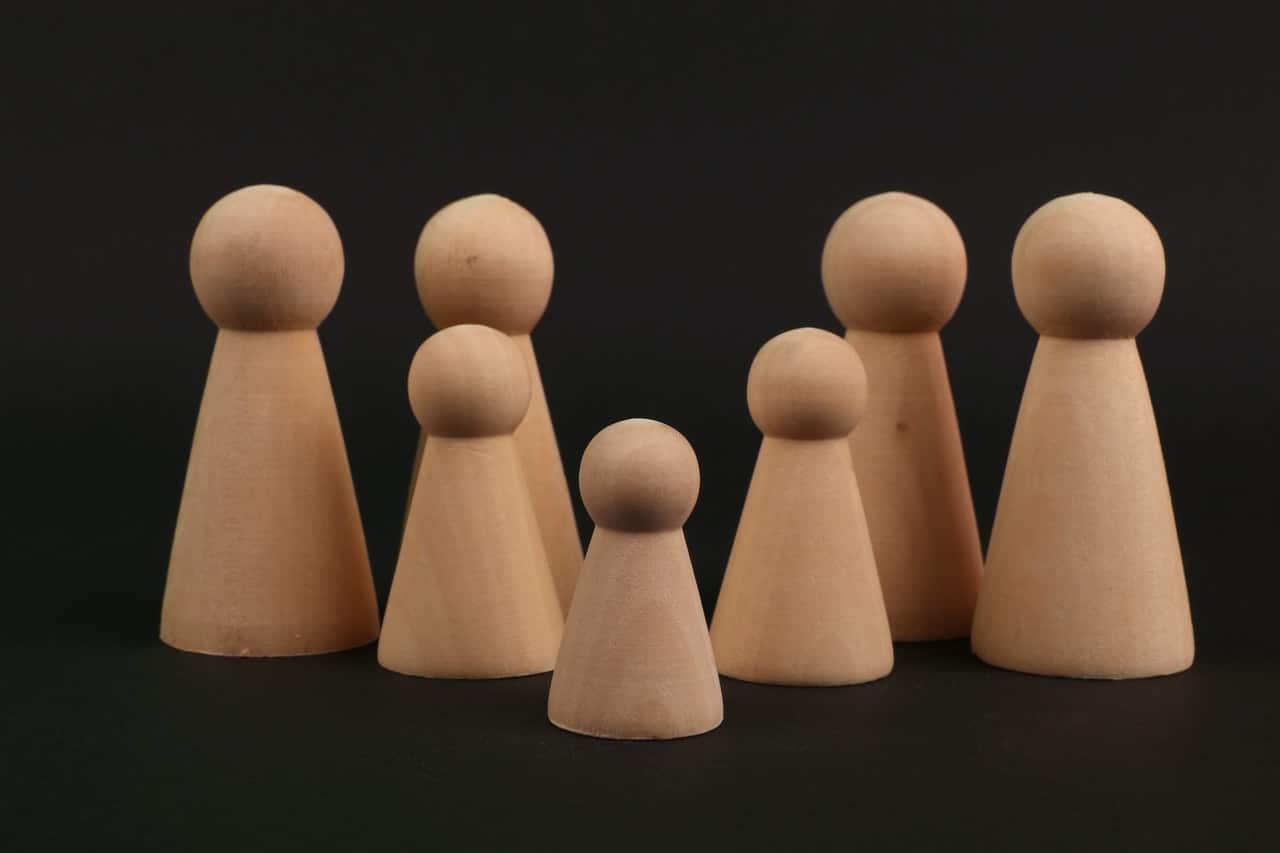Wooden figures representing family sponsorships in Canada