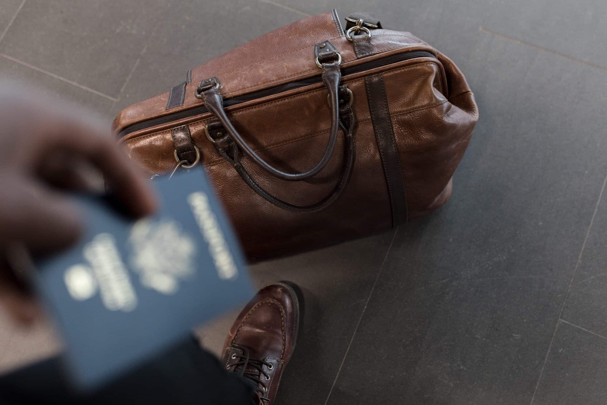 Passport and duffel bag representing changes to the post graduate work permits in Canada
