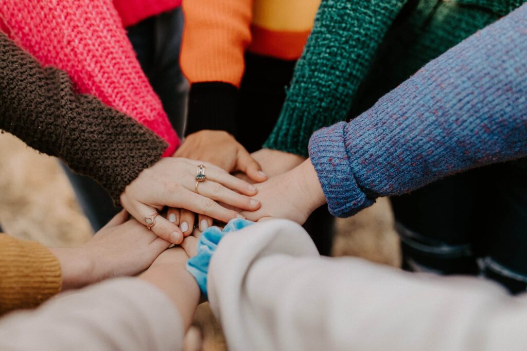 Families holding hands representing an invitation to the parents and grandparents program in Canadian Immigration