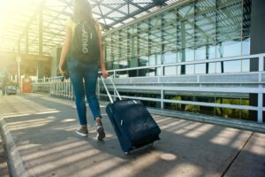 Person walking through airport representing Canada's changes to temporary residents and introducing a cap on visitor visas
