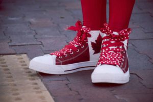 Sneakers with Canadian colours and maple leaf representing changes to the post-graduate work permit program in Canada
