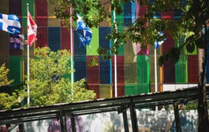 Building with waving flags representing Canada's immigration pilot programs