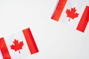 Canadian flags representing immigration regulations on open work permits and international students