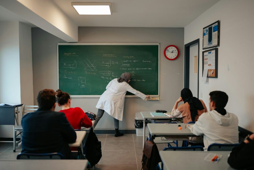 a woman in a white lab coat teaching