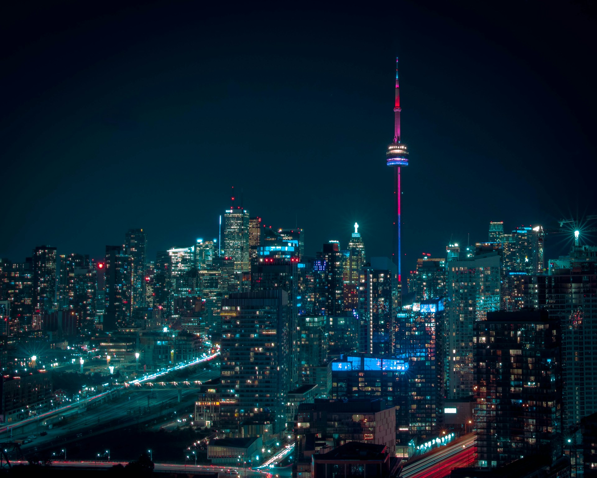 The Toronto skyline at night with The CN Tower and office and apartment buildings lit up against a midnight-blue sky, representing Best Law Firms Canada.