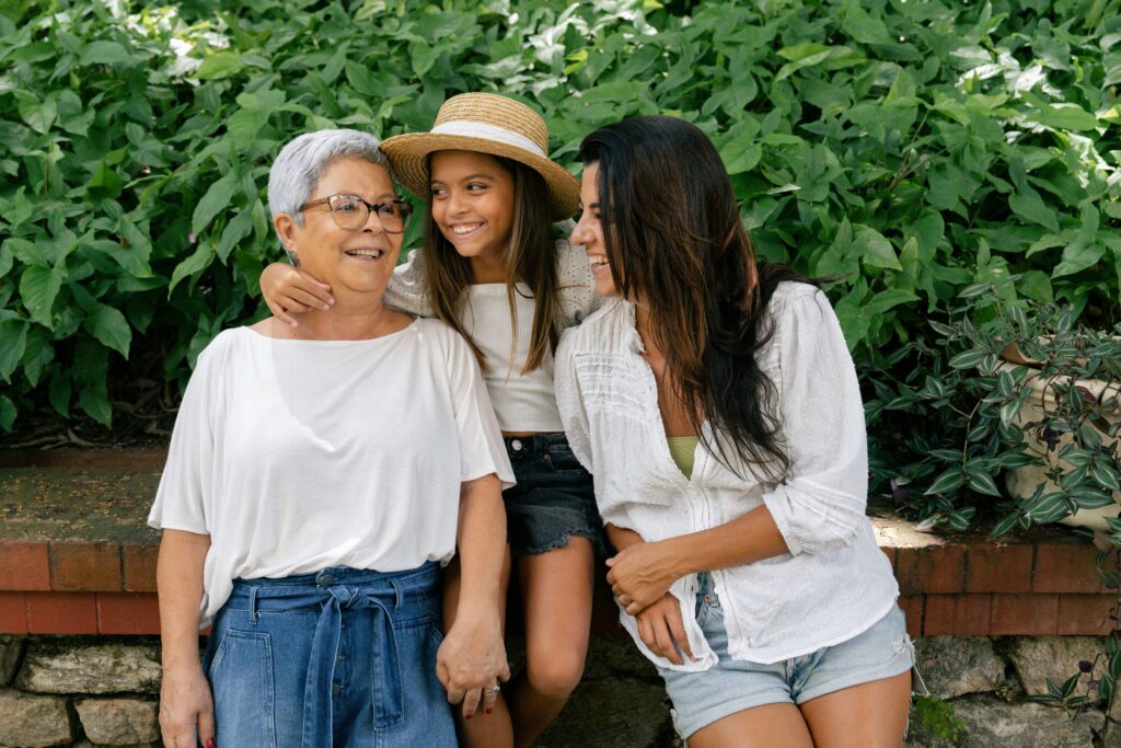 A multi-generational family of women sitting on a park bench, representing Canadian citizenship and descent law
