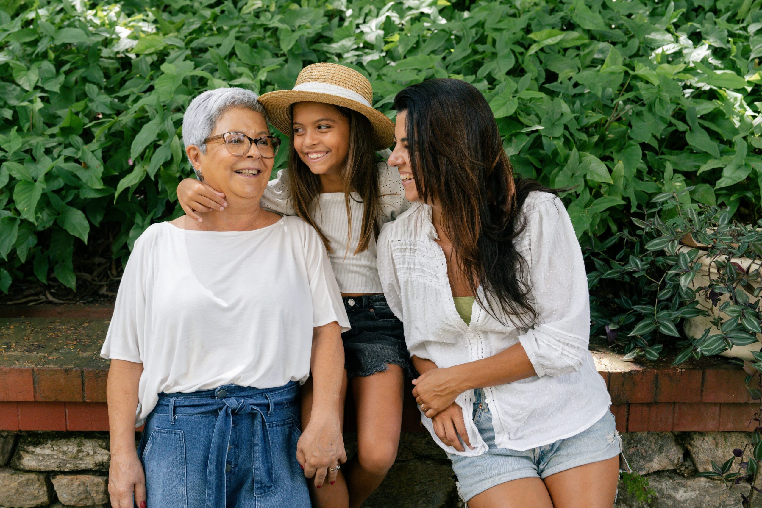 A multi-generational family of women sitting on a park bench, representing Canadian citizenship and descent law