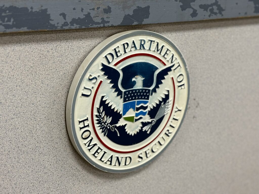 Crest of the US Department of Homeland Security, representing US travel and border crossing regulations