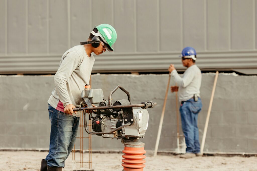 Two men working on a construction site, representing foreign workers and worker permits in Canada